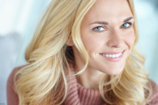 Face of smiling blonde young woman