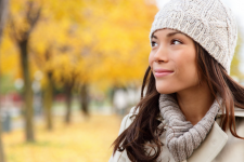 Woman looking at trees during fall in Anchorage, AK (model)