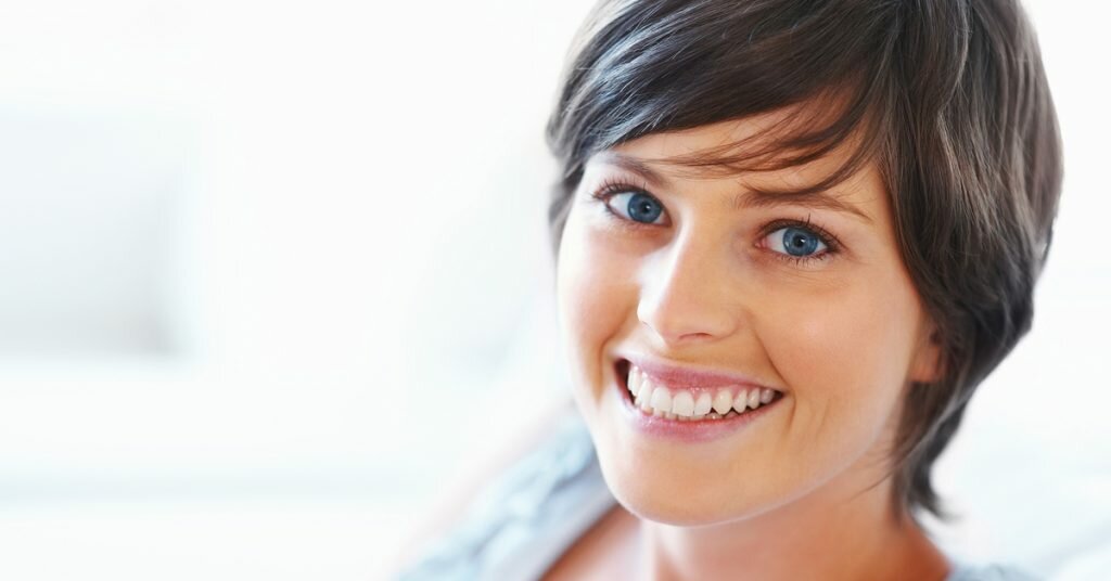 Face of smiling woman with short dark hair