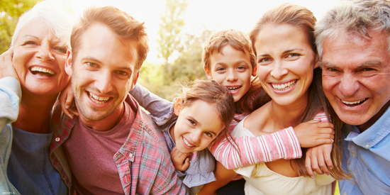 Smiling parents, grandparents, and children
