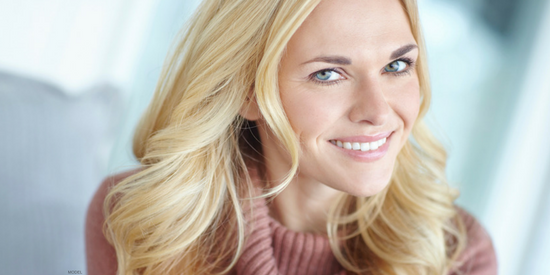 Face of smiling blonde young woman
