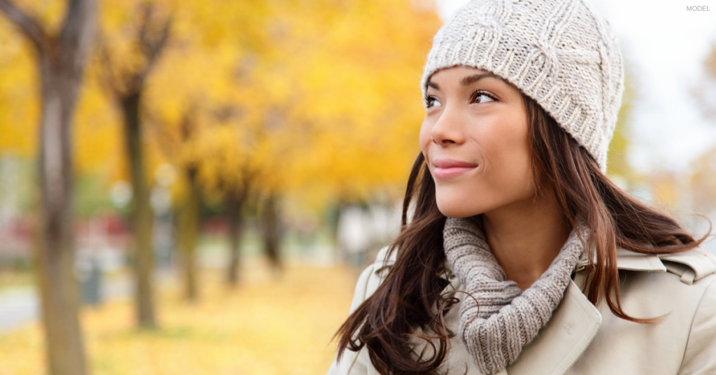 Woman looking at trees during fall in Anchorage, AK (model)